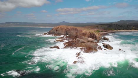 aerial drone view towards the cliffs at the headland bay at the moonee beach reserve