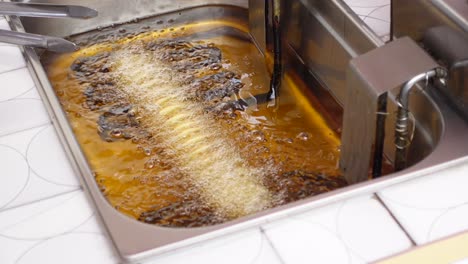 closeup of food frying in a deep fryer