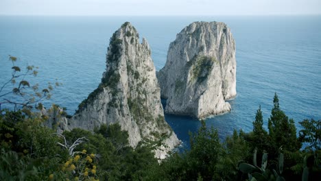 Beautiful-side-view-of-the-Faraglioni-in-Capri,-in-Italy,-the-famous-cliffs-of-this-beautiful-island-during-a-sunny-day-in-spring---01