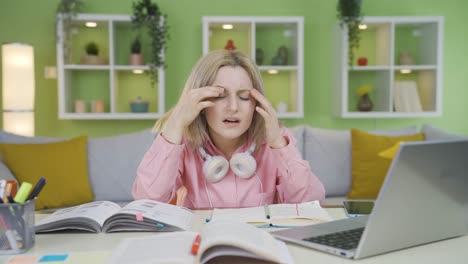 university student girl who has a headache while studying.