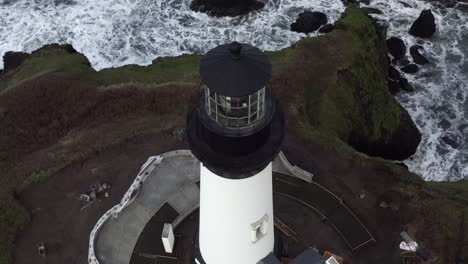 amazing aerial view, yaquina head lighthouse, tilt up orbit around island