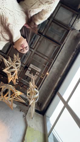 woman looking down at christmas decorations in a cafe