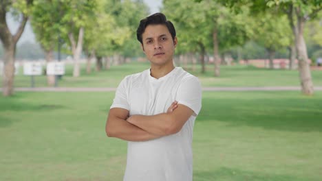 portrait of confident indian man standing crossed hands