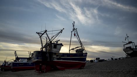 static time lapse of a fishing boat on a beach at sunset