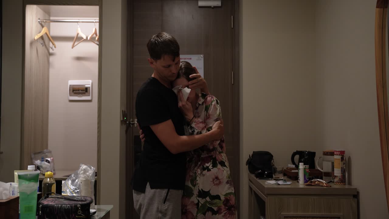 Man comforts crying woman in distress. Emotional couple support