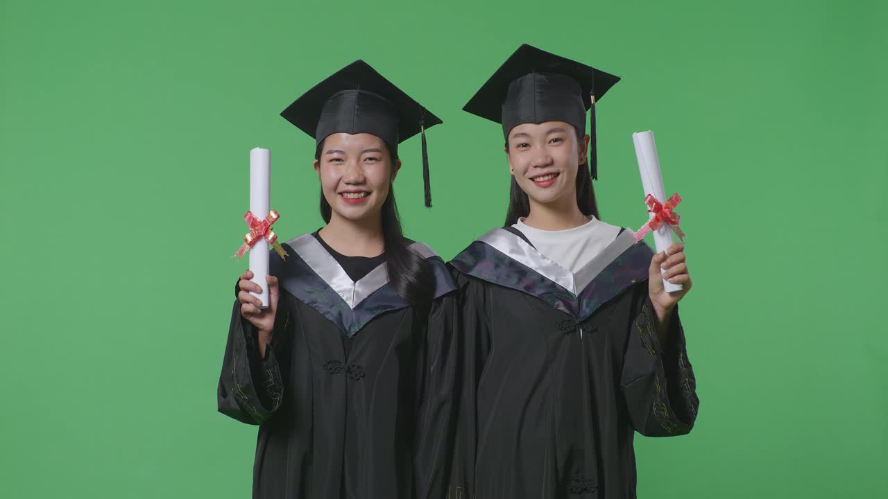 卒業証書を持つ2人の卒業生