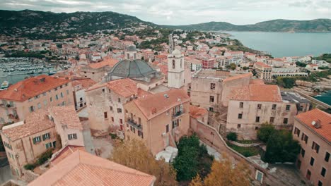 Aerial,-Drone-flying-low-over-old-town-of-Calvi,-Corsica,-France