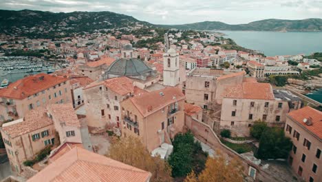 aerial, drone flying low over old town of calvi, corsica, france