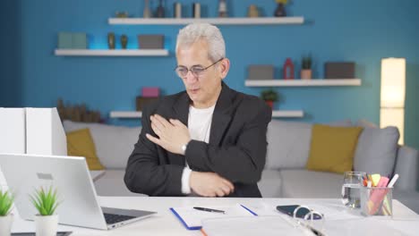 home office worker man itching with allergies.