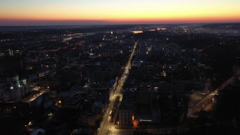 aerial view of a city at night during sunset