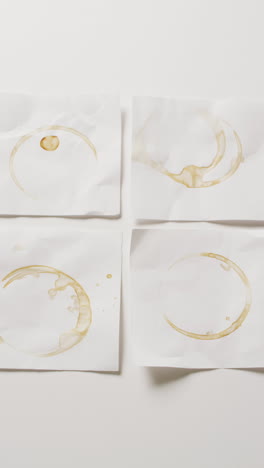 vertical video of close up of four white memo notes with circle glass marks with copy space