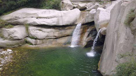 Small-pond-and-waterfall-under-the-Hua-shan-mountain,-famous-tourist-attraction,-Shaanxi-province,-China