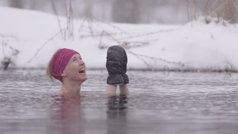 close up of a female ice bather looking up with joy at the falling snow