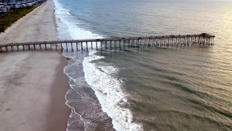 Aerial-push-toward-the-pier-at-kure-beach-nc,-north-carolina