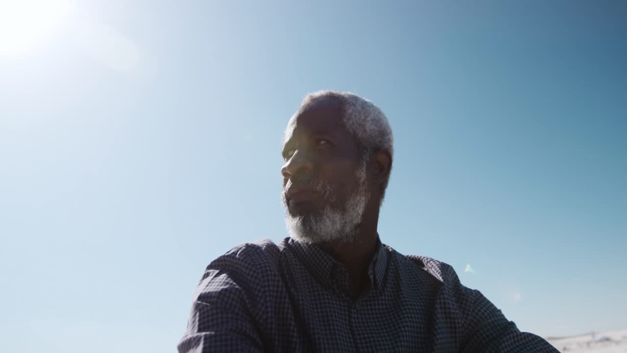 Senior man sitting on the sand