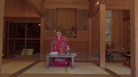 latin beautiful woman sitting at japanese traditional house at okinawa world naha japan wearing ryusou dress kimono tilt shot