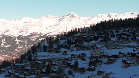 Drone aerial of Chandolin, Switzerland. Traditional alpine village with wooden chalets, snowy slopes and mountain peaks. Perfect winter tourism, travel and cinematic stock footage