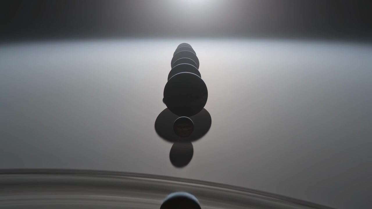 Vertical column of dark droplets falling under gravity in dish, with backlight, ripples, shadows