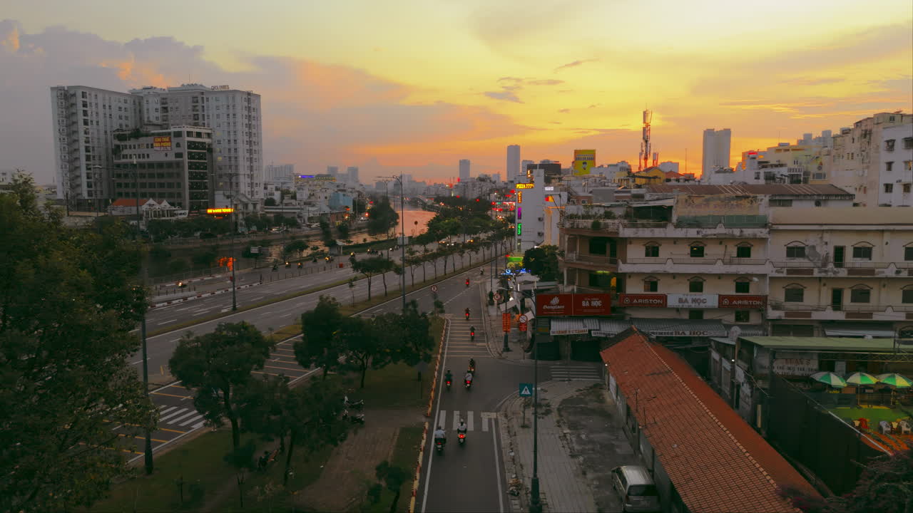 Experience the vibrant energy of Ho Chi City's iconic Ho Chi Road as the sun sets in this captivating aerial footage