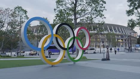 olympic rings sculpture in front of the japan national stadium in tokyo
