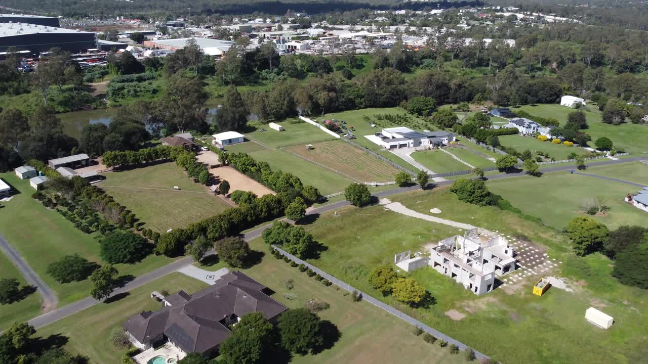 4K Aerial Shot of a lush green rural suburb with large private properties in Australia