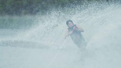 young man waterski slalom cut rope hits tip of ski slow motion