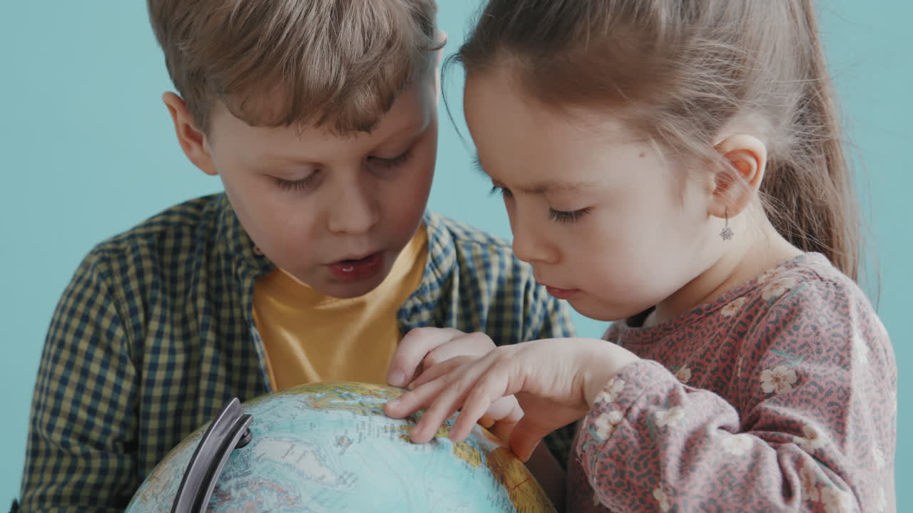 Cute Children Using World Globe