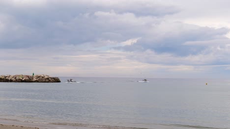 Boats-Coming-To-The-Beach-After-Cruising-On-The-Coast-Of-Malaga-In-Spain