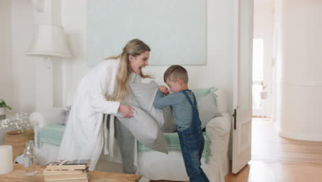 happy-mother-and-son-play-catch-running-through-house-mom-playing-game-having-pillow-fight-with-little-boy-enjoying-fun-weekend-together-4k-footage