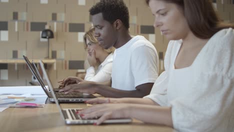 row of focused professionals sitting at table