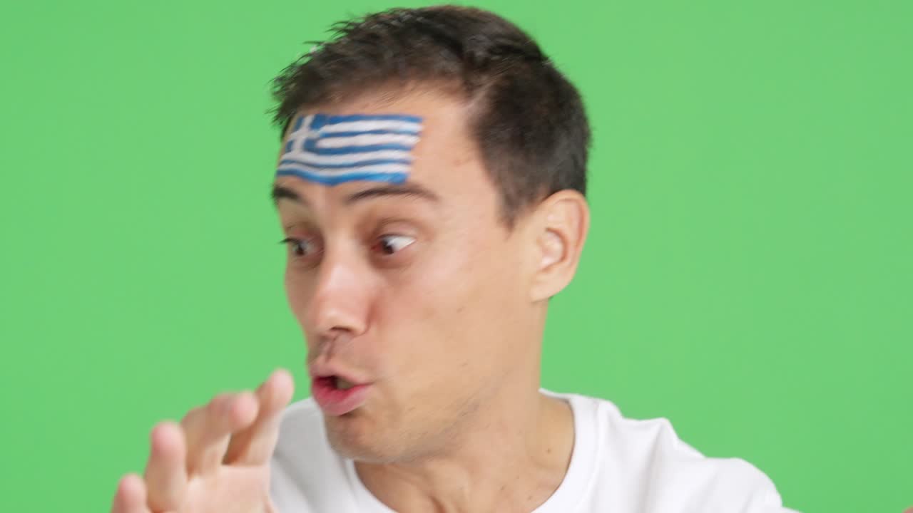 Close up of a man supporting greek team