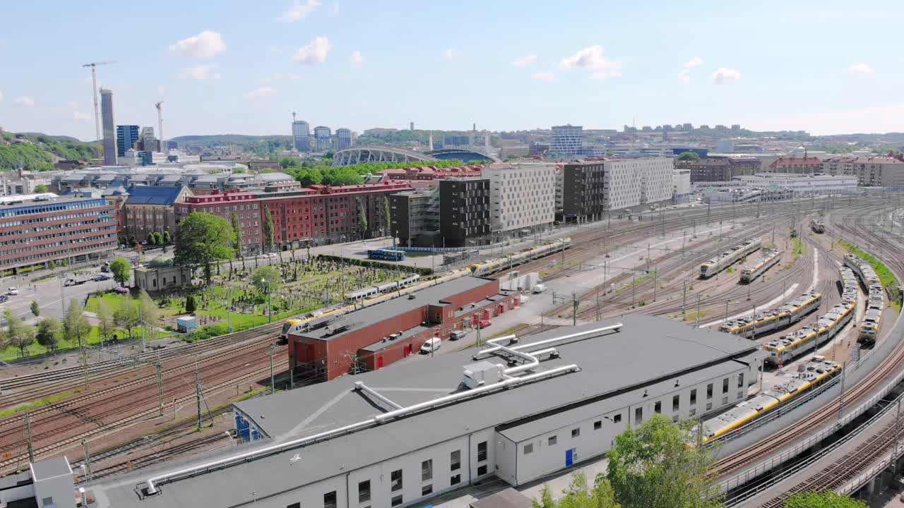 Aerial view of Gothenburg white and yellow trains passing through rail yard