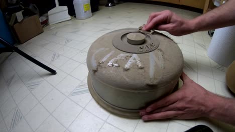 Old-dusty-cake-sever-being-cleaned-by-hand-on-the-floor-of-a-kitchen-in-a-old-home