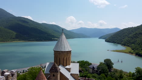 revealing dolly shot of the ananuri churches and fortress wall and the beautiful lakes and mountains