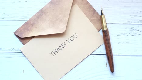 thank you note with vintage envelope and pen