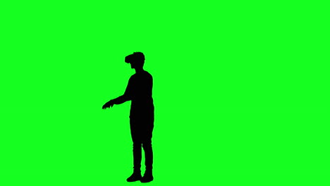 silueta de un hombre con gafas vr jugando un juego en pantalla verde