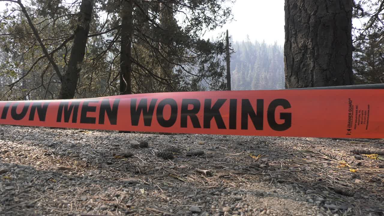 caution men working sign at scene