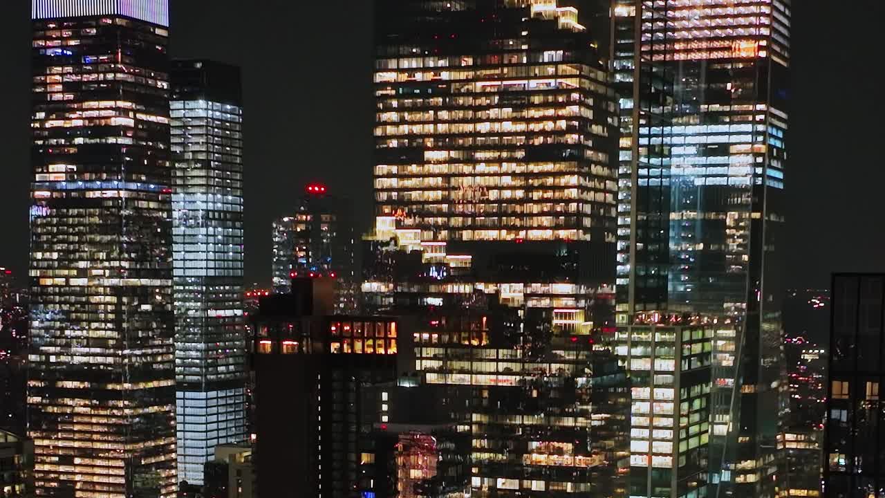 Night view of illuminated skyscrapers in New York City captured from above