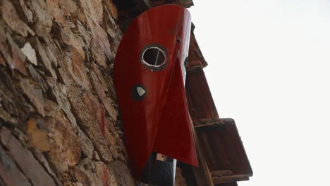 Big-Careto-Carnival-Mask-on-Podence-Stone-Wall,-Portugal