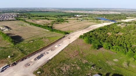 pulling away from a large expanse of road that is being built across the countryside