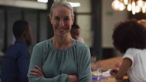 portrait of caucasian businesswoman in a meeting room looking to camera smiling