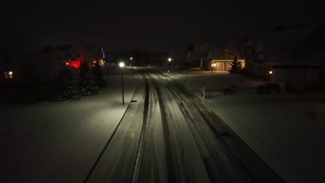 Snow-covered-upscale-American-neighborhood-at-night