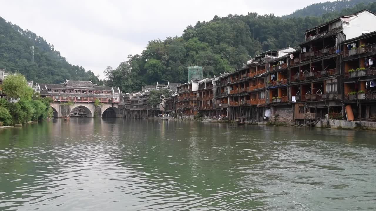 Fenghuang Ancient Town in Hunan Province, China, is a famous historic town known for its traditional Chinese architecture, stilt houses, cobblestone streets, and scenic riverside views