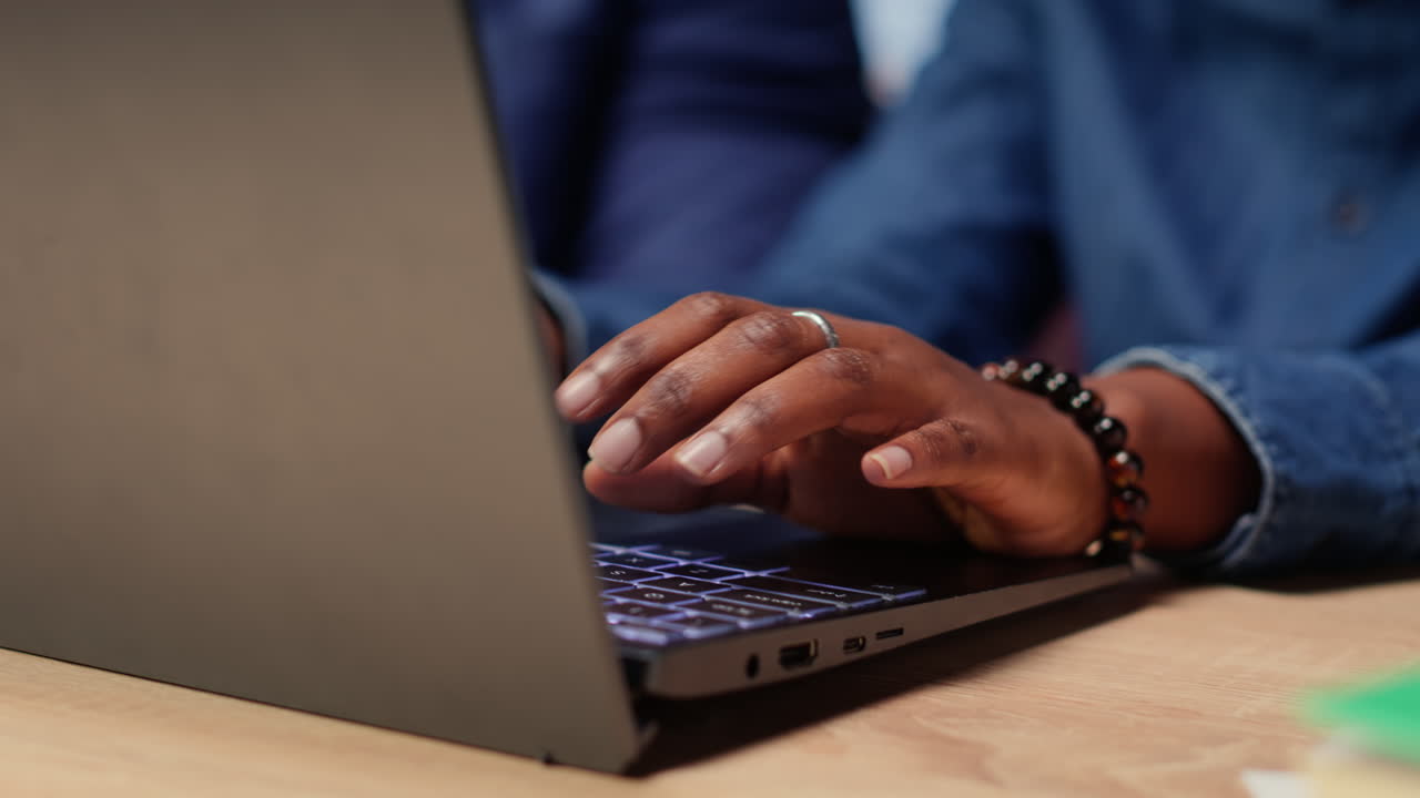 Young couple at desk reading research papers and multitasking