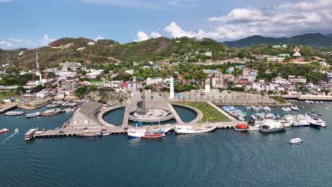 aerial view of a port city with a lighthouse and various boats