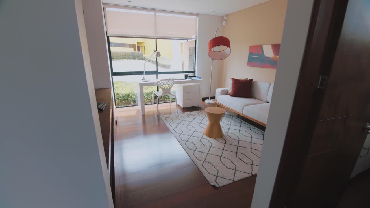 Guided tour highlights the house's charm, focusing on the elegant staircase and inviting living room, showcasing the warm ambiance of the space