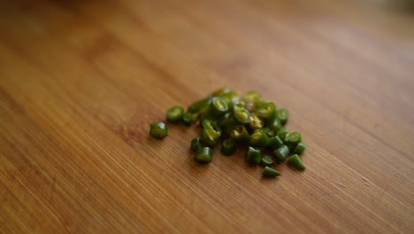 chopped spicy, green chilies on chopping board. pile of chilies.