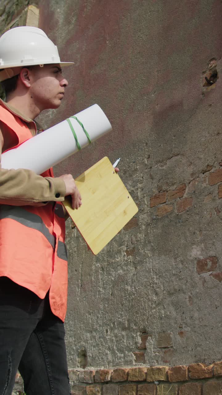 Engineer Using The Pen To Take Notes About The Old Building