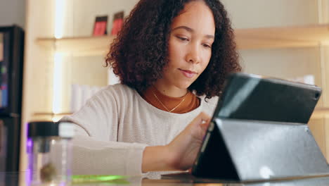 woman browsing on tablet with cannabis jar