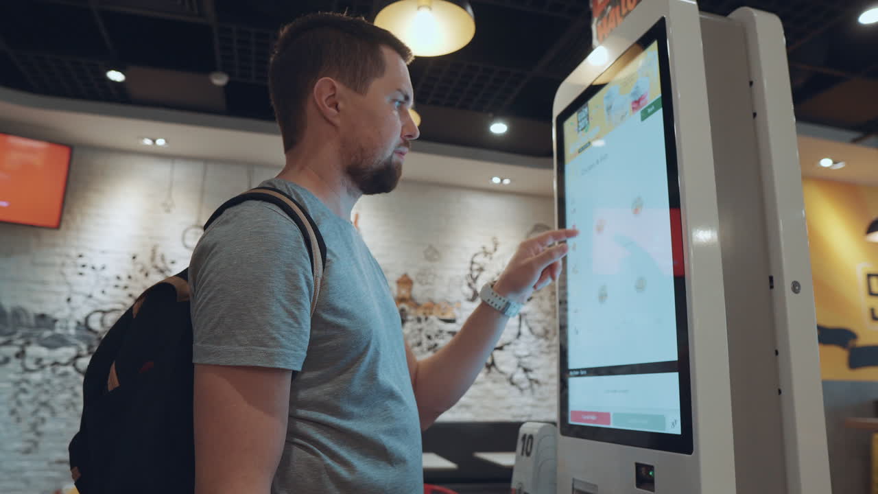 Man Ordering Food at a Restaurant Kiosk